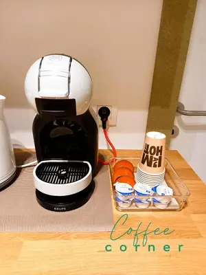 a coffee maker on a counter with a tray of cups at Comfy Stay 9052 in Ghent