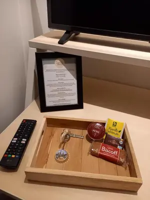 a tray with a remote control and a box of chocolate at Comfy Stay 9052 in Ghent