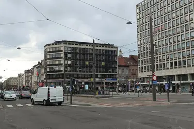 a white van driving down a city street with buildings at Antwerp Home Sweet Home 1 Double and 2 Single Beds in Antwerp