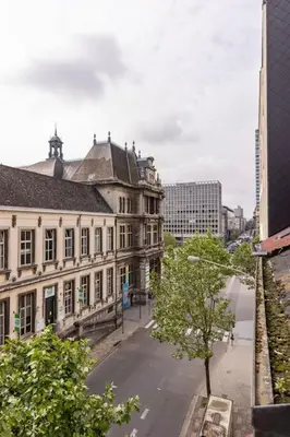 an empty street in a city with buildings at Antwerp Home Sweet Home 1 Double and 2 Single Beds in Antwerp