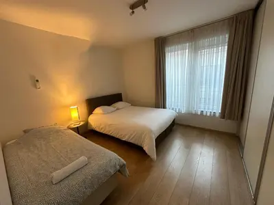a hotel room with two beds and a window at 2 Bedroom Apartment in Center with Breathtaking View in Brussels
