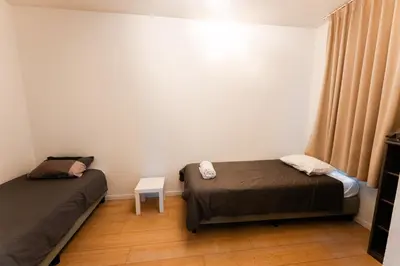 two beds in a small room with a window at 2 Bedroom Apartment in Center with Breathtaking View in Brussels