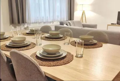 a dining room table with bowls and plates on it at 2 Bedroom Apartment in Center with Breathtaking View in Brussels