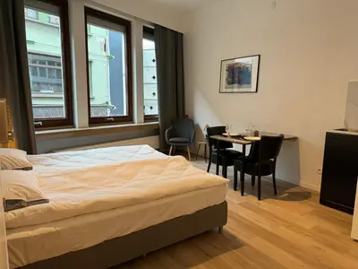 a bedroom with a bed and a table and chairs at Loft with big terrace city center MEIR in Antwerp