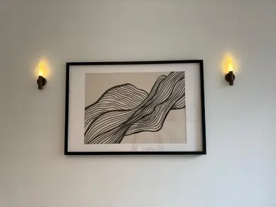 a framed picture on a wall with two lights at Loft with big terrace city center MEIR in Antwerp