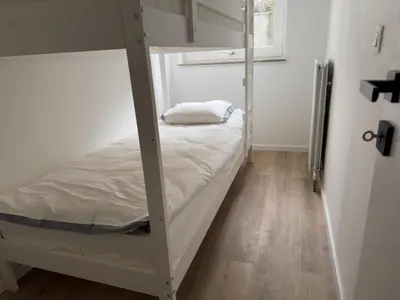 a bedroom with a bunk bed and a wooden floor at Loft with big terrace city center MEIR in Antwerp