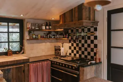 a kitchen with a stove and a counter top at La Petite Foret Cottage in Brussels Countryside in Asse
