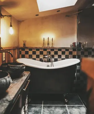 a large bath tub in a kitchen with a sink at La Petite Foret Cottage in Brussels Countryside in Asse