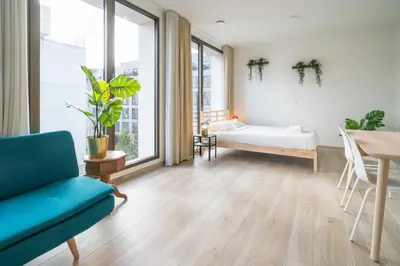 a living room with a couch and a table at Opera Apartments in the Center of Antwerp in Antwerp