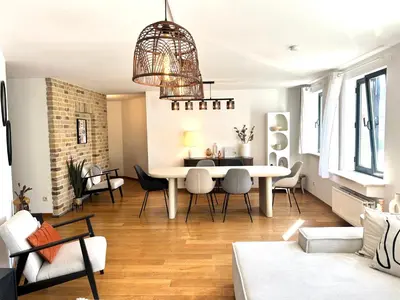 a living room with a white table and chairs at Friends & Family Brussels Atomium 6-8 pers in Grimbergen