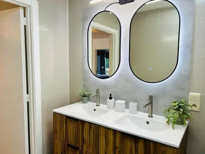 a bathroom with a sink and a mirror at Friends & Family Brussels Atomium 6-8 pers in Grimbergen