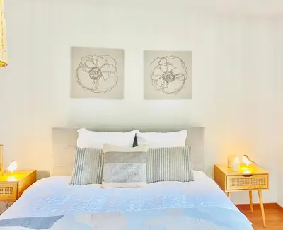 a bedroom with a bed with three pictures on the wall at Friends & Family Brussels Atomium 6-8 pers in Grimbergen
