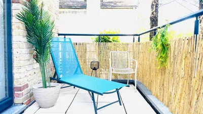 a blue chair on a patio with a fence at Friends & Family Brussels Atomium 6-8 pers in Grimbergen