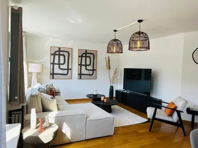 a living room with a white couch and a tv at Friends & Family Brussels Atomium 6-8 pers in Grimbergen