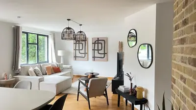 a living room with a white couch and a table at Friends & Family Brussels Atomium 6-8 pers in Grimbergen