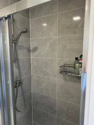 a shower with a shower head in a bathroom at Superbe appartement une chambre in Brussels