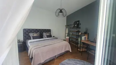a bedroom with a bed and a table and a desk at ailes Center 1 in Brussels