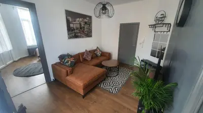 an overhead view of a living room with a brown couch at ailes Center 1 in Brussels