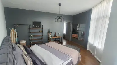 a bedroom with a bed and a blue wall at ailes Center 1 in Brussels