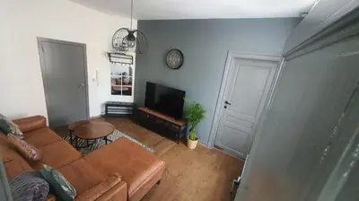 a living room with a couch and a flat screen tv at ailes Center 1 in Brussels