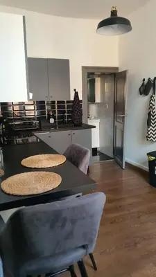 a kitchen with a table and chairs in a room at ailes Center 1 in Brussels