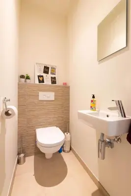 a bathroom with a toilet and a sink at Casa Matti - Modern Apartment with Canal View and Terrace in Ghent
