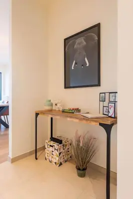 a desk in a room with a picture on the wall at Casa Matti - Modern Apartment with Canal View and Terrace in Ghent