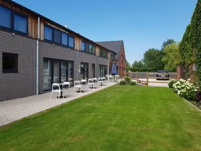 a row of chairs sitting outside of a building at B&B De Vlierbeek in Sint-Niklaas
