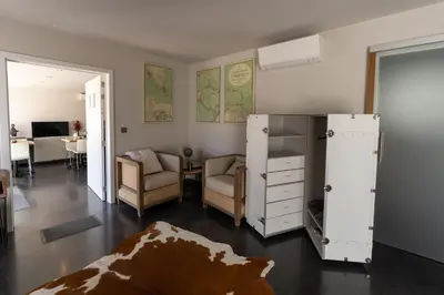 a living room with a refrigerator and a couch and chairs at B&B De Vlierbeek in Sint-Niklaas