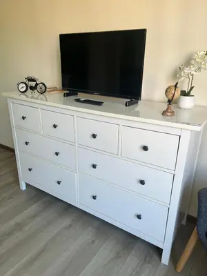 a white dresser with a television on top of it at Coeur de Bruxelles, Grand-Place et Mannekenpiss in Brussels
