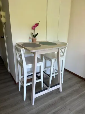 a white table and chairs with a vase on it at Coeur de Bruxelles, Grand-Place et Mannekenpiss in Brussels