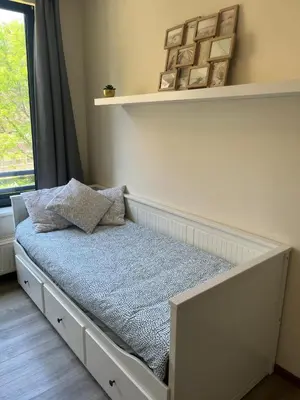 a small bed in a room with a window at Coeur de Bruxelles, Grand-Place et Mannekenpiss in Brussels