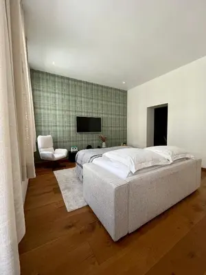 a bedroom with a large bed and a television at Stilias Apartment 4P Brussels City in Brussels