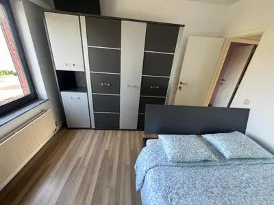 a bedroom with a bed and a large closet at Rooms for Tomorrowland 2026 in Boom