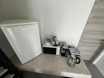 a kitchen with a counter top with a refrigerator at Rooms for Tomorrowland 2026 in Boom