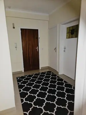 a hallway with a black and white floor with a door at Luxurious 4 in Brussels