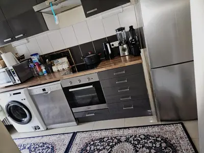 a kitchen with a washer and a stove and a refrigerator at Luxurious 4 in Brussels