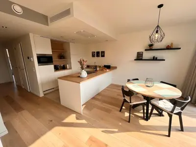 a kitchen and dining room with a table and chairs at Casa Matti - Modern Apartment with Garden View and Terrace in Ghent