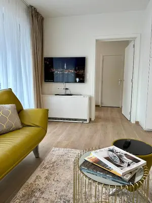 a living room with a couch and a tv at Urbanstay Suites - Jacqmain Downtown Suite in Brussels