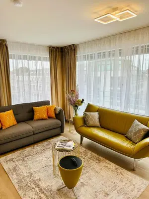 a living room with two couches and a table at Urbanstay Suites - Jacqmain Downtown Suite in Brussels