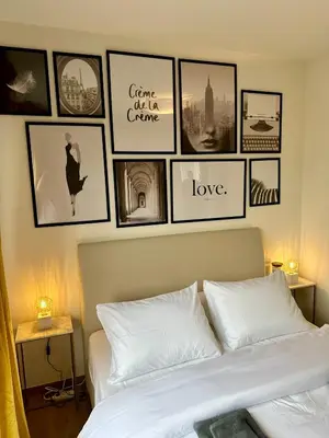 a bedroom with pictures on the wall above a bed at Urbanstay Suites - Jacqmain Downtown Suite in Brussels