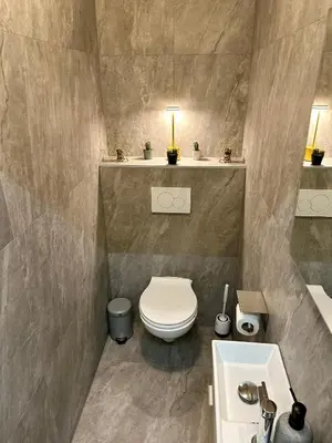 a bathroom with a toilet and a sink at Urbanstay Suites - Jacqmain Downtown Suite in Brussels