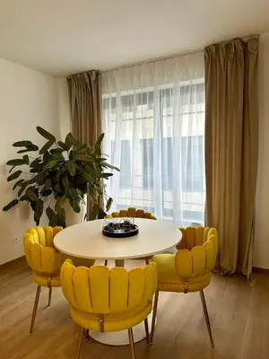 a dining room with a table and yellow chairs at Urbanstay Suites - Jacqmain Downtown Suite in Brussels