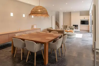 a dining room with a wooden table and chairs at Casa Tintos in Sint-Amands