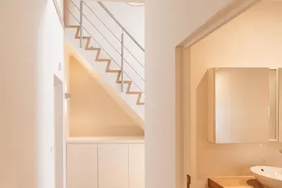a staircase in a bathroom with a sink and a mirror at Casa Tintos in Sint-Amands