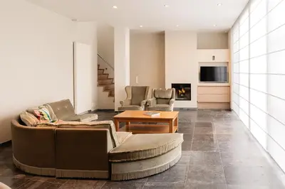 a living room with a couch and a table at Casa Tintos in Sint-Amands