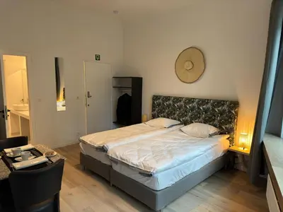 a bedroom with a bed and a clock on the wall at Two bedroom loft in the city center by the Meir in Antwerp