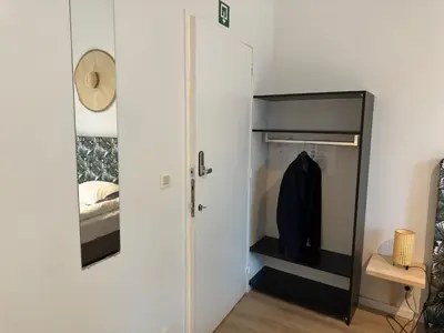 a bedroom with a closet and a mirror at Two bedroom loft in the city center by the Meir in Antwerp