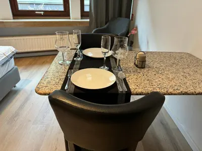 a table with wine glasses and plates on it at Two bedroom loft in the city center by the Meir in Antwerp