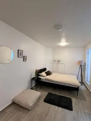 a bedroom with two beds and a mirror at Rue blaes Appartement in Brussels